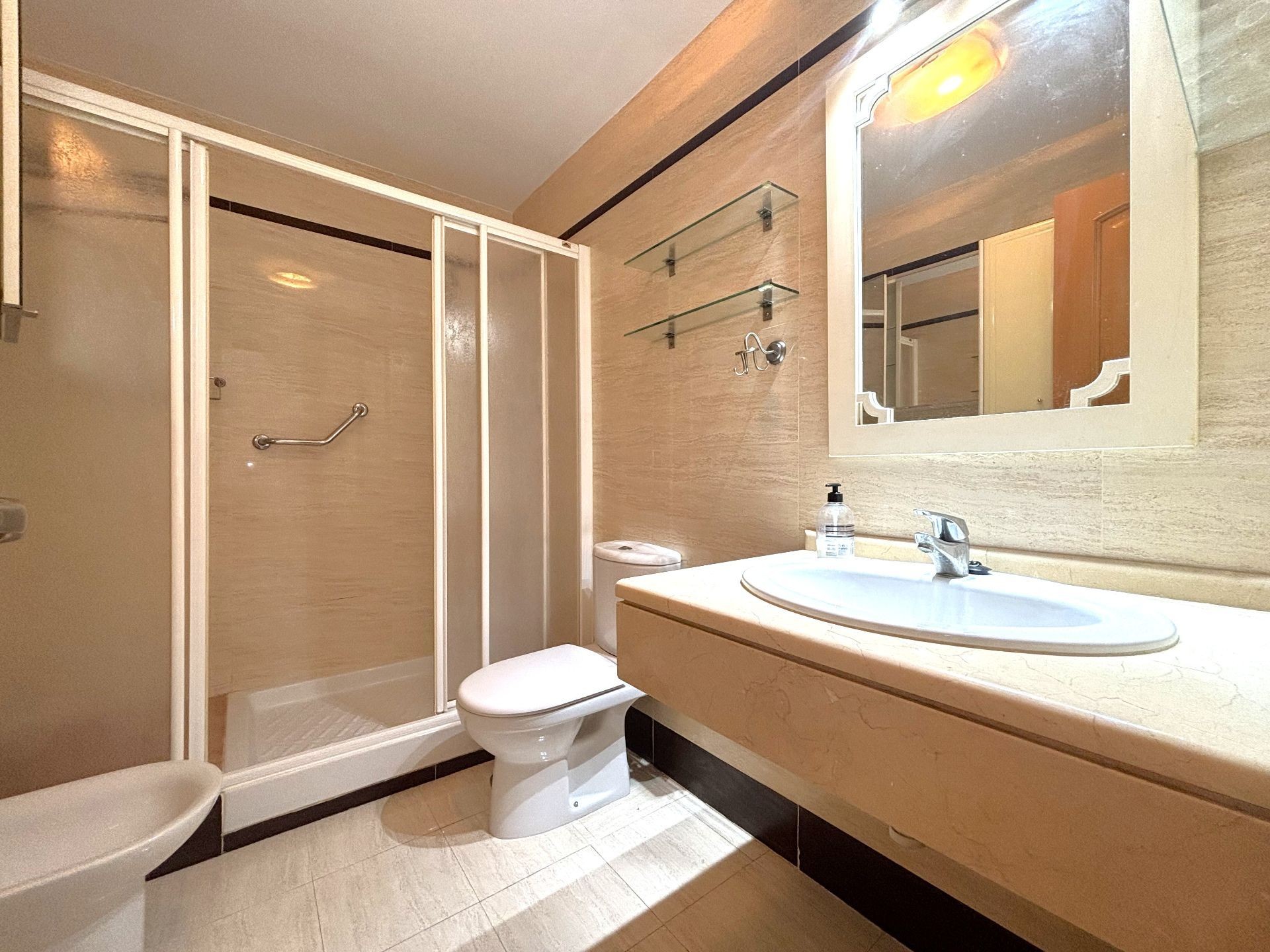Bathroom with shower, sink and large mirror