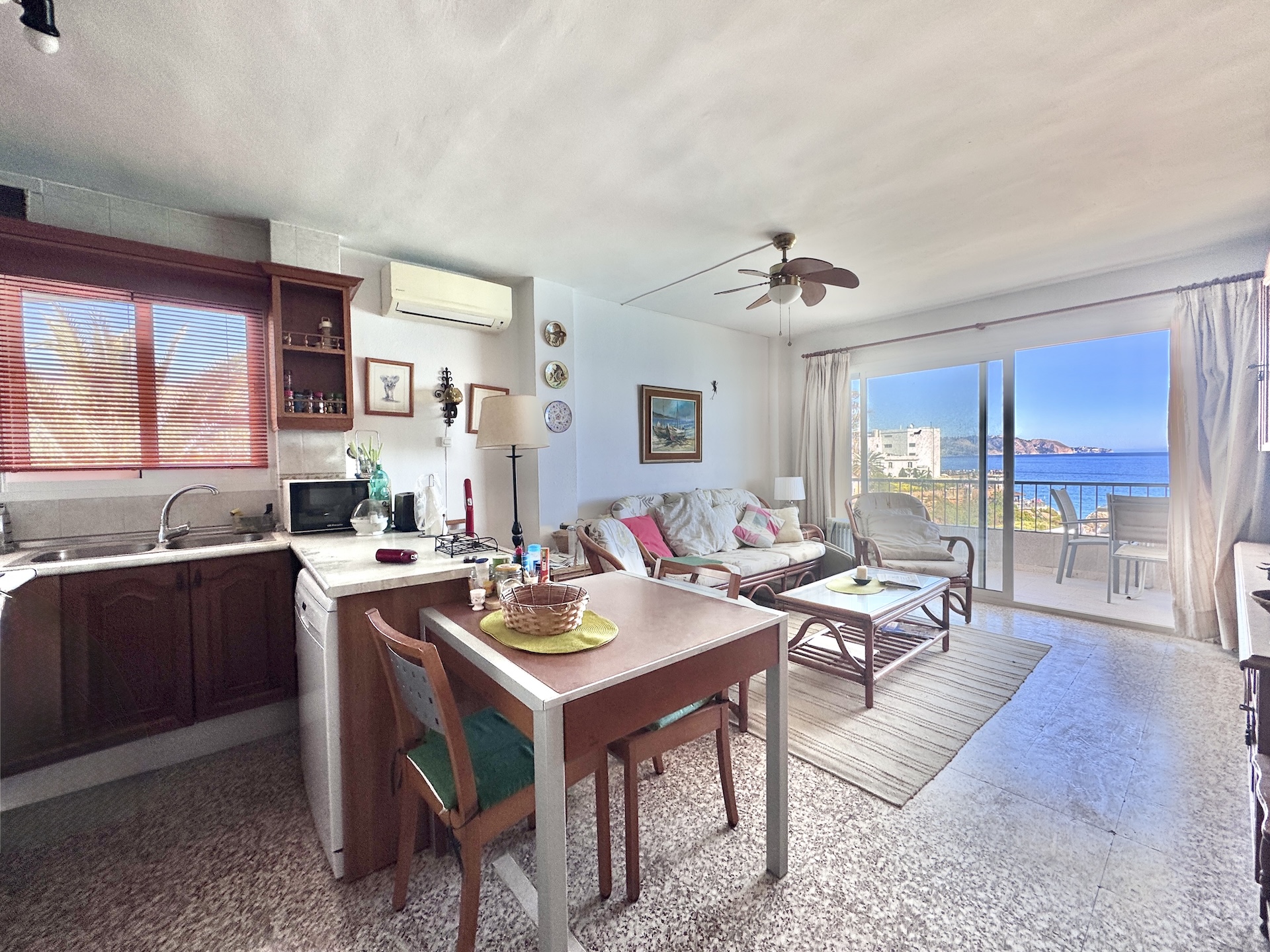 Living-dining room with open kitchen and sea views