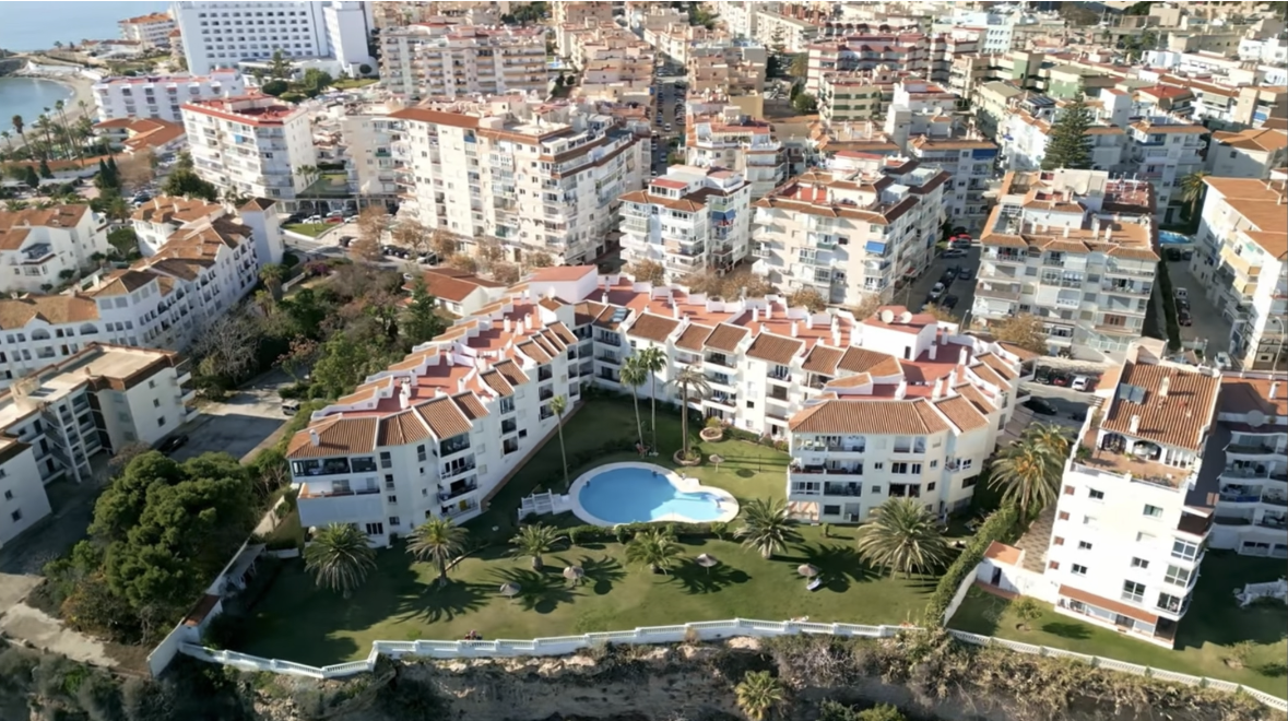 Aerial view of complex with pool and gardens