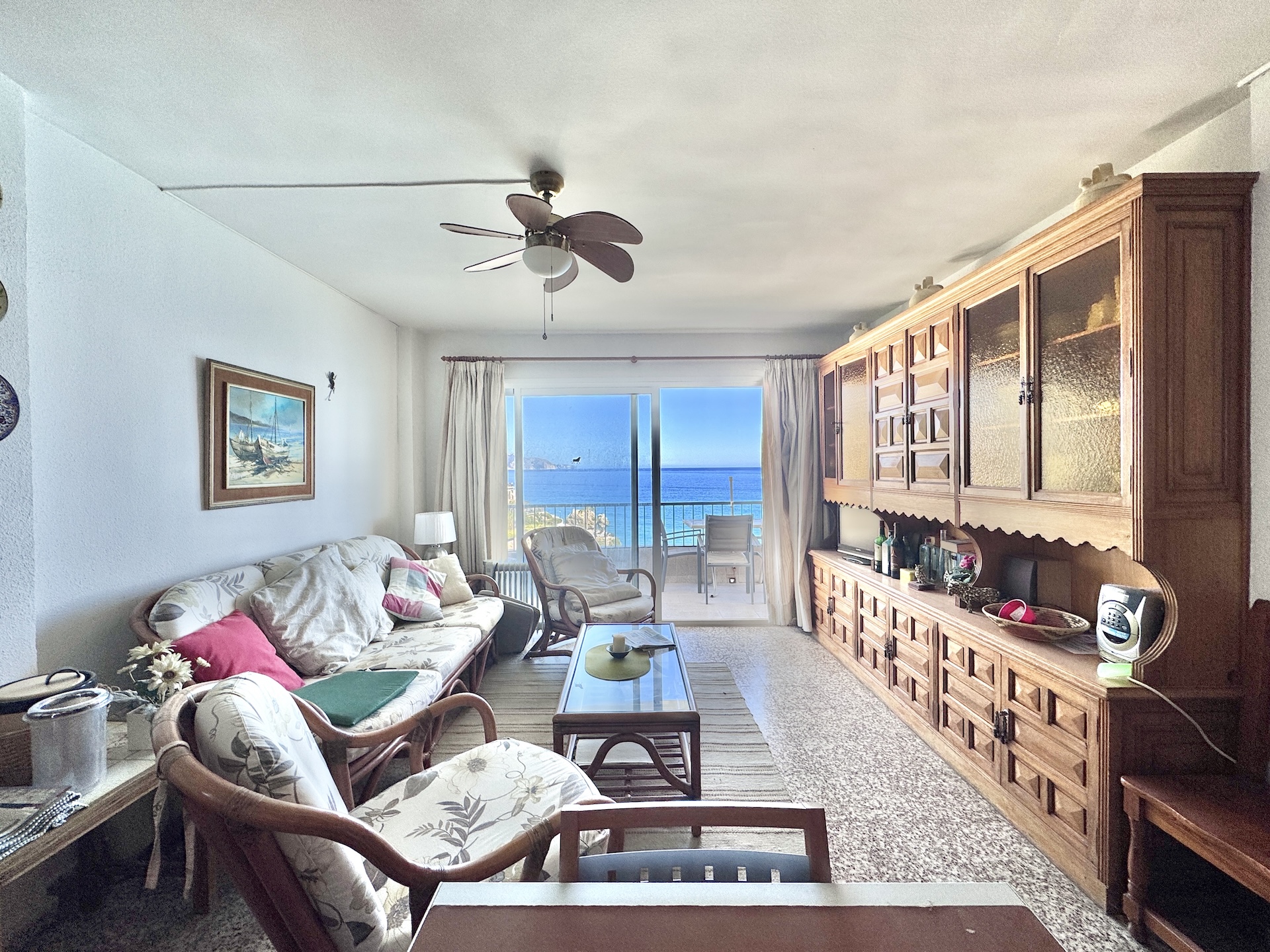 Living room with sofa, armchairs and terrace access