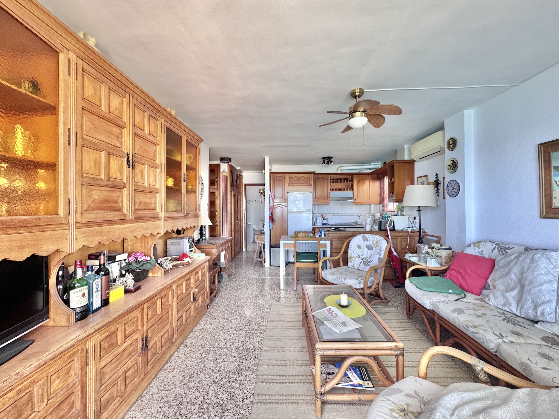 Spacious living room with open kitchen and dining area
