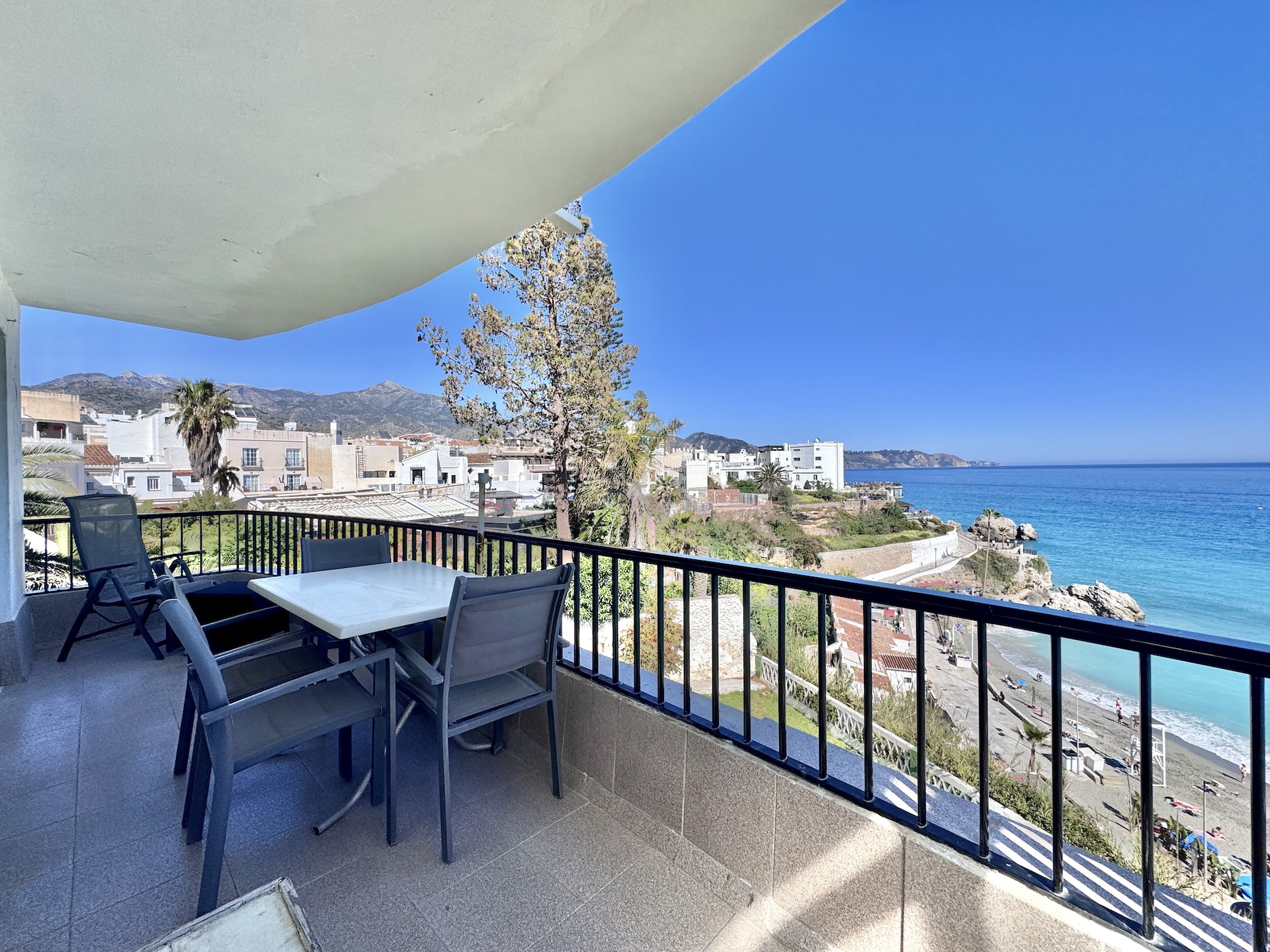 Terrace with table and coastal views