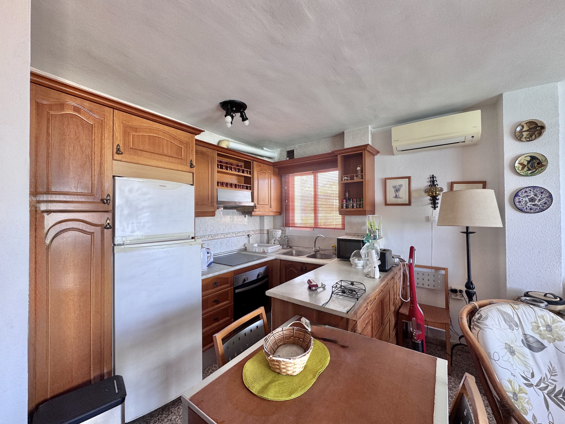 Open kitchen with wooden cabinets and breakfast bar