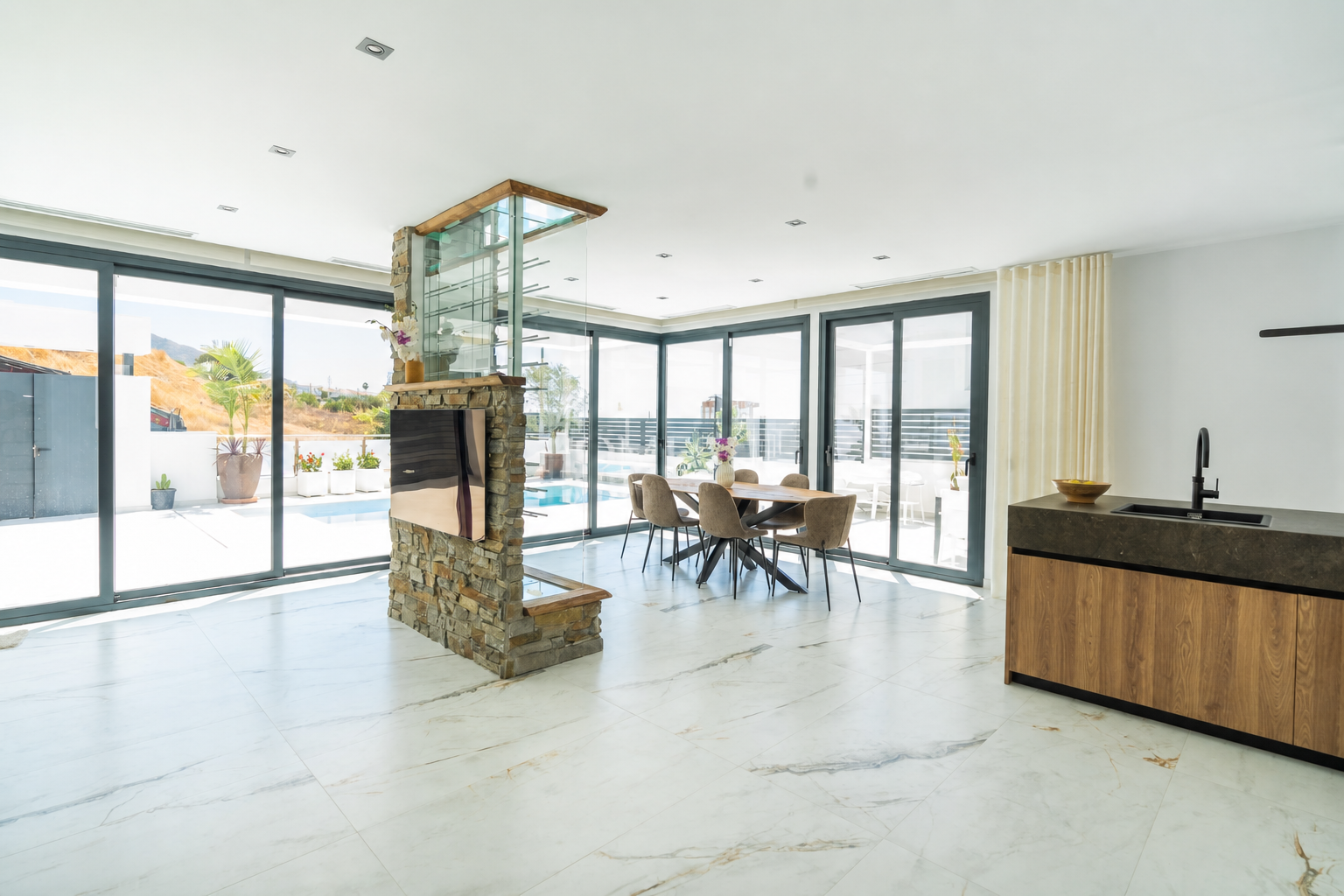 Bright living-dining room with green sofa and patio views