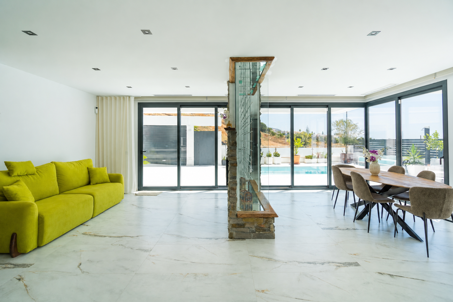 Modern kitchen with central island and green cabinetry