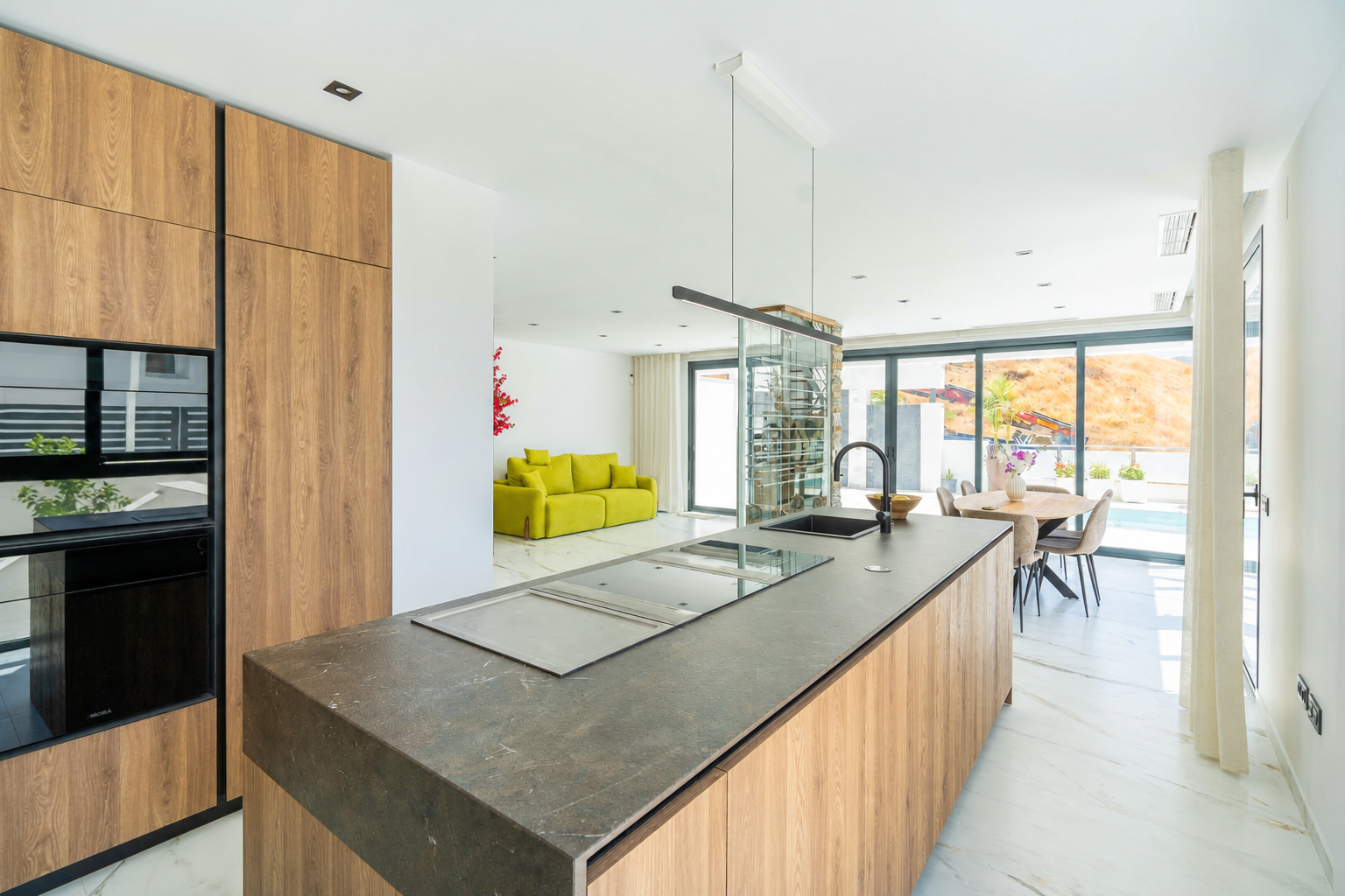Living-dining room with central fireplace and green sofa