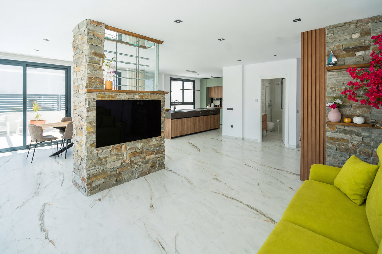 Open living room with central fireplace and kitchen beyond