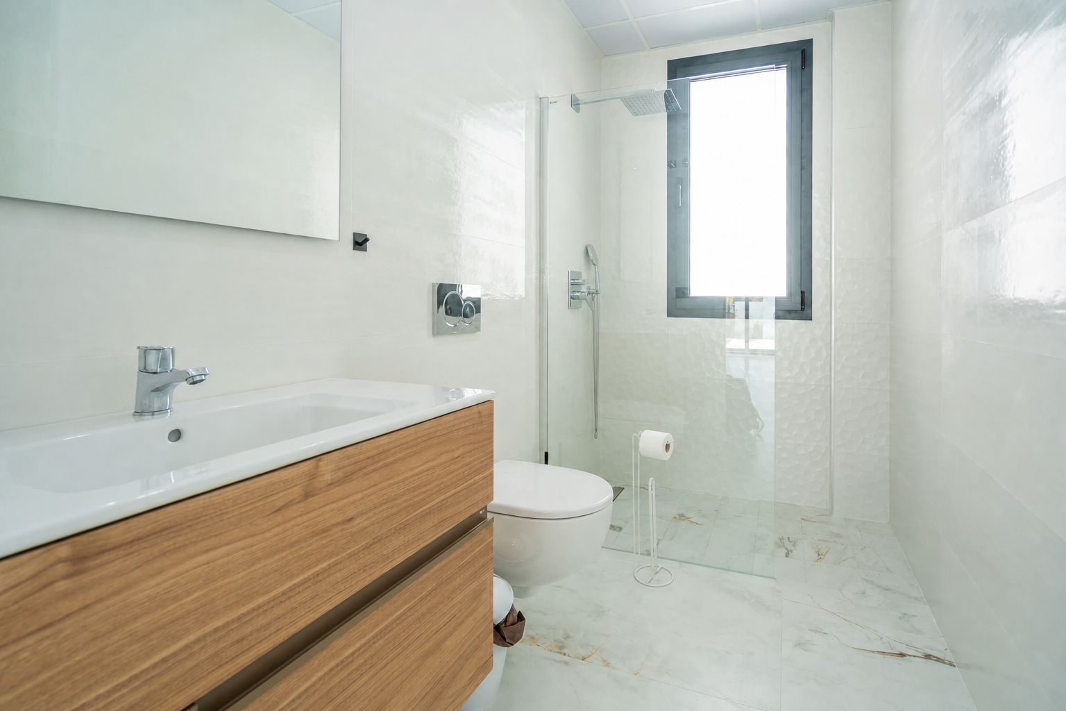 Modern bathroom with glass shower and wood vanity
