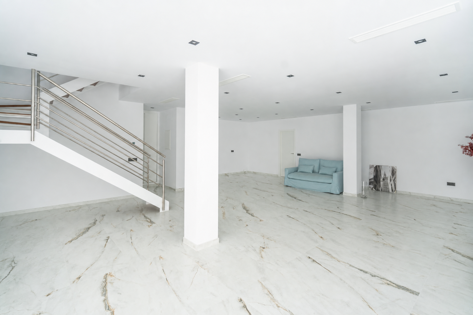 Large open interior space with staircase and sofa