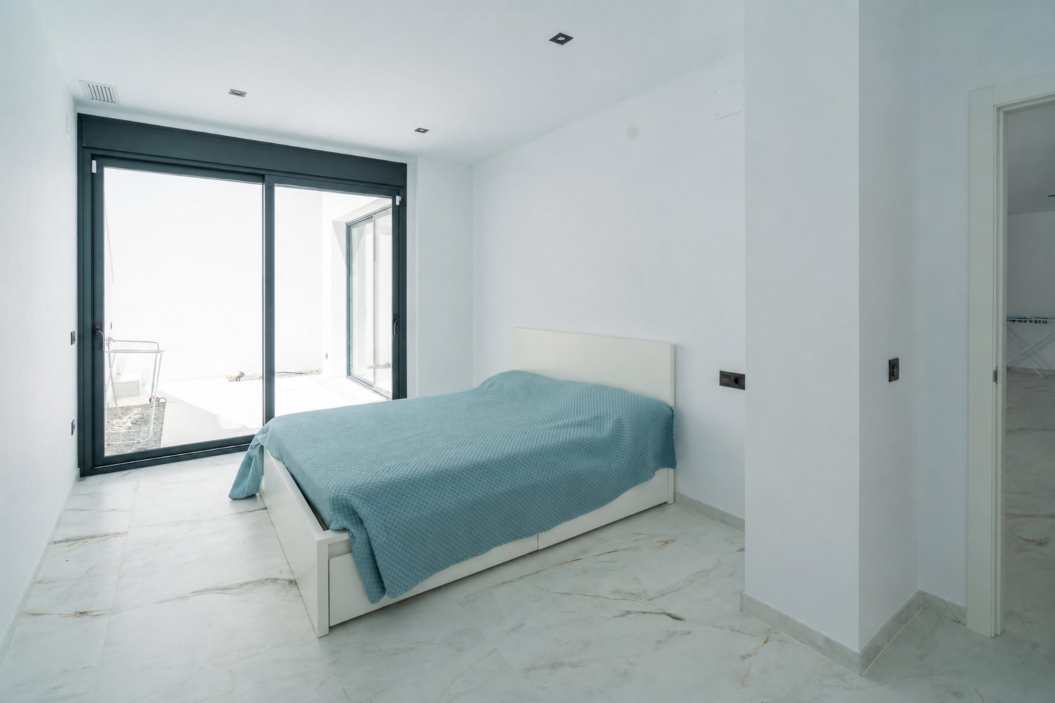 Small bedroom with single bed and exterior access