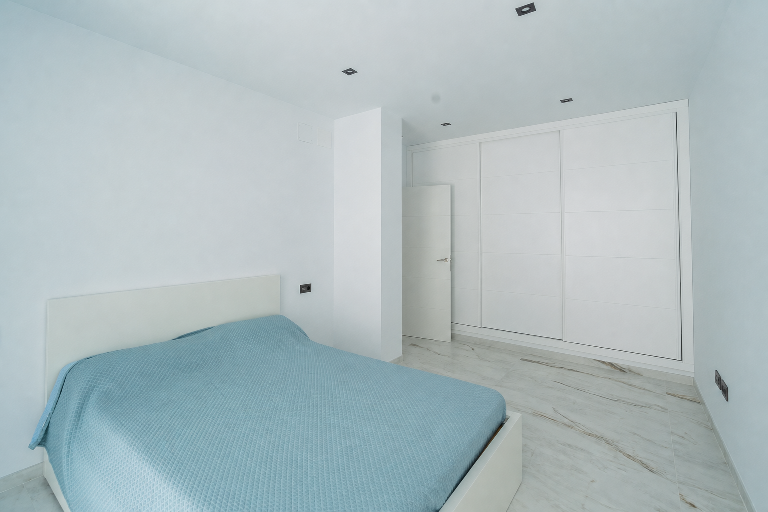 Small bedroom with built-in wardrobe and single bed