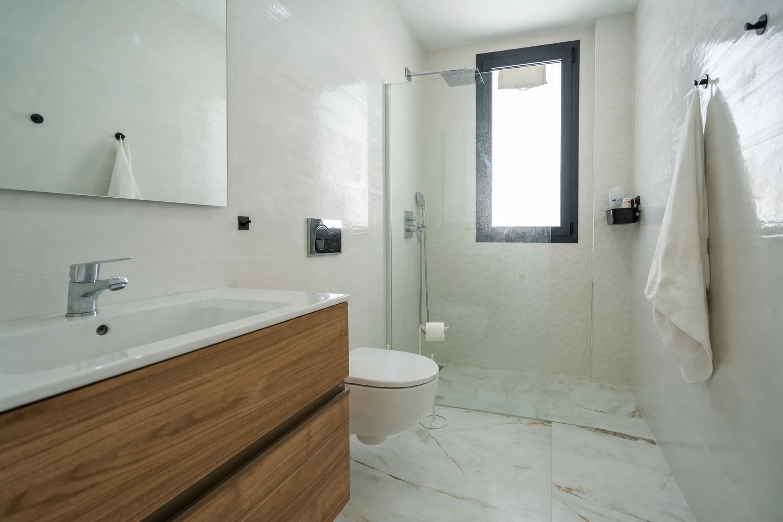 Compact bathroom with shower and wood vanity
