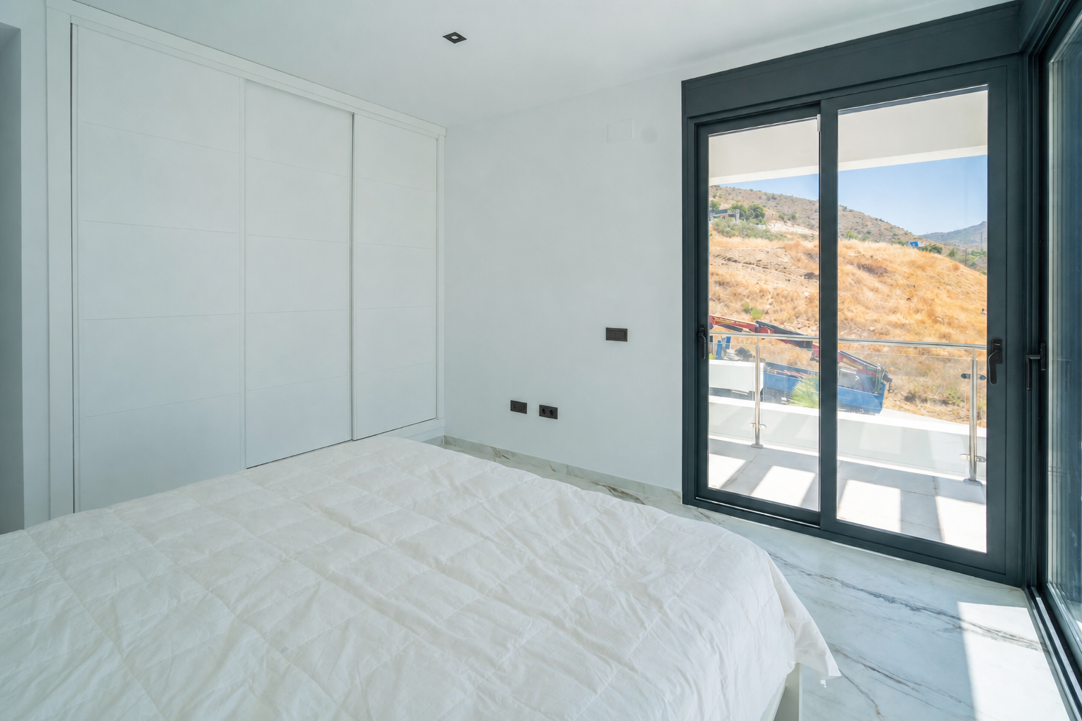 Bedroom with built-in wardrobe and terrace access