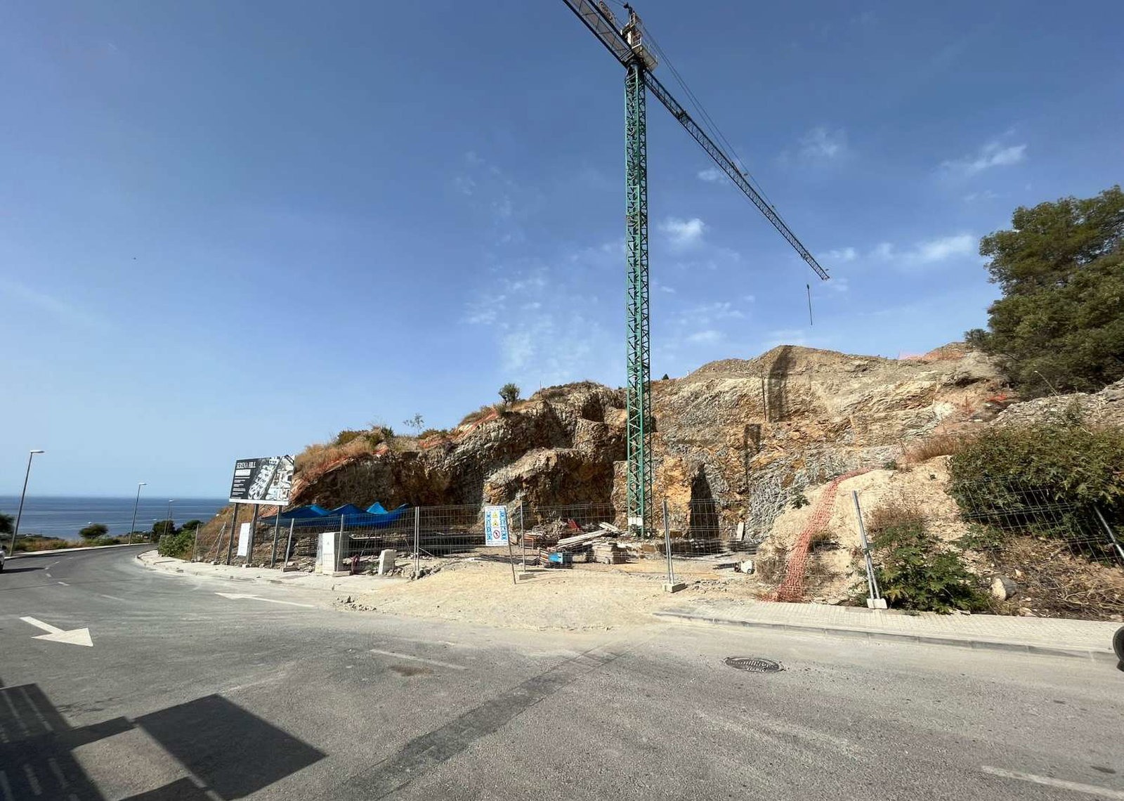 Construction site plot with crane by the sea