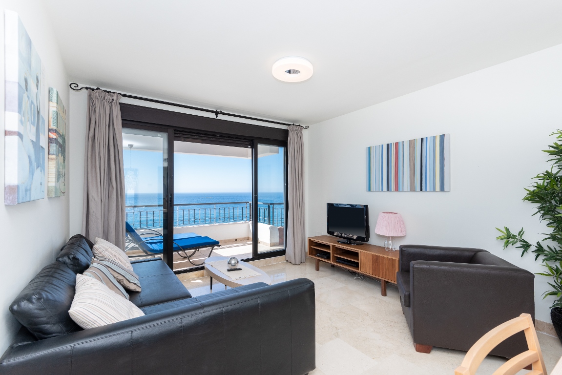 Living room with terrace access and sea views