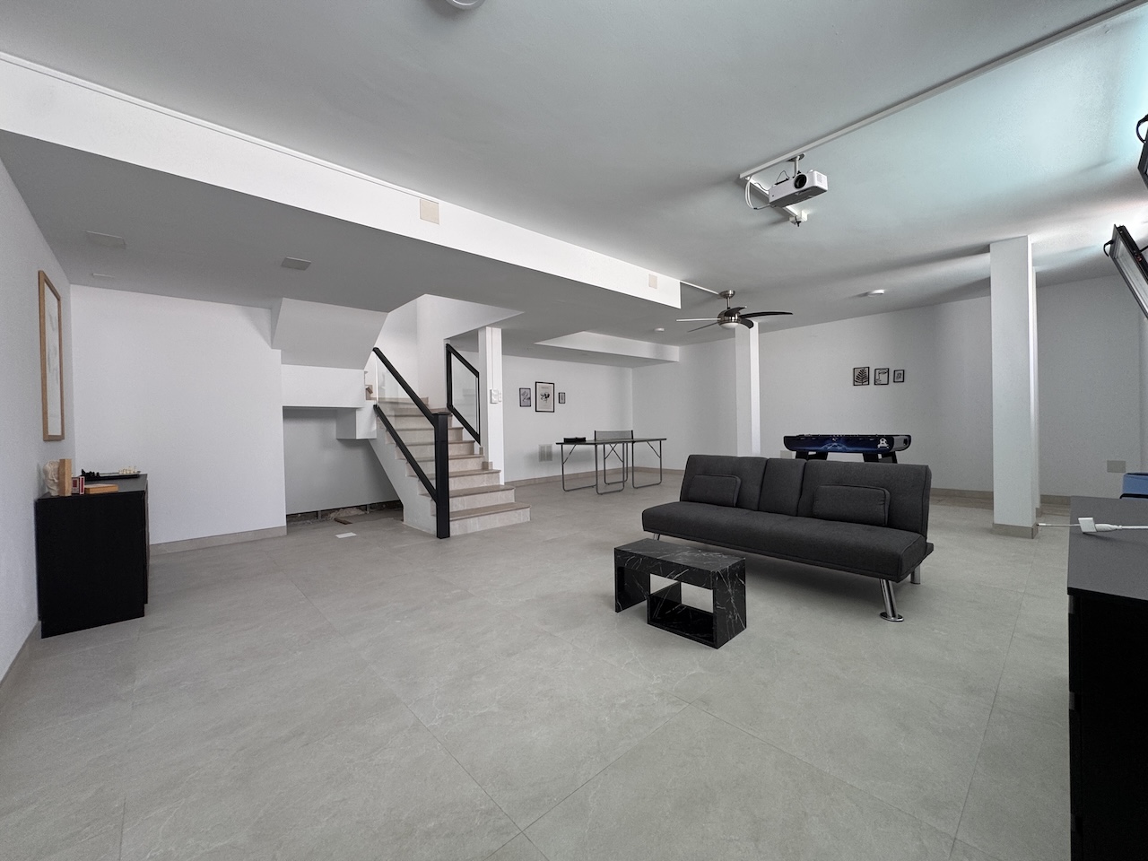 Large multipurpose basement with stairs and leisure area