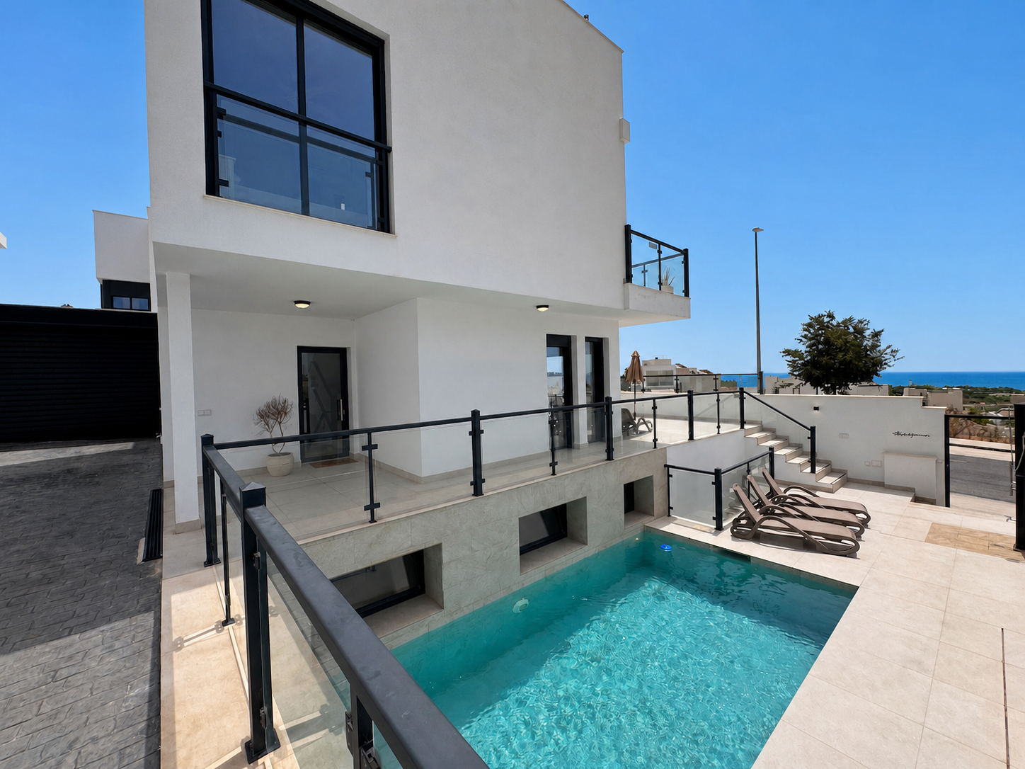Outdoor pool beside the modern house facade