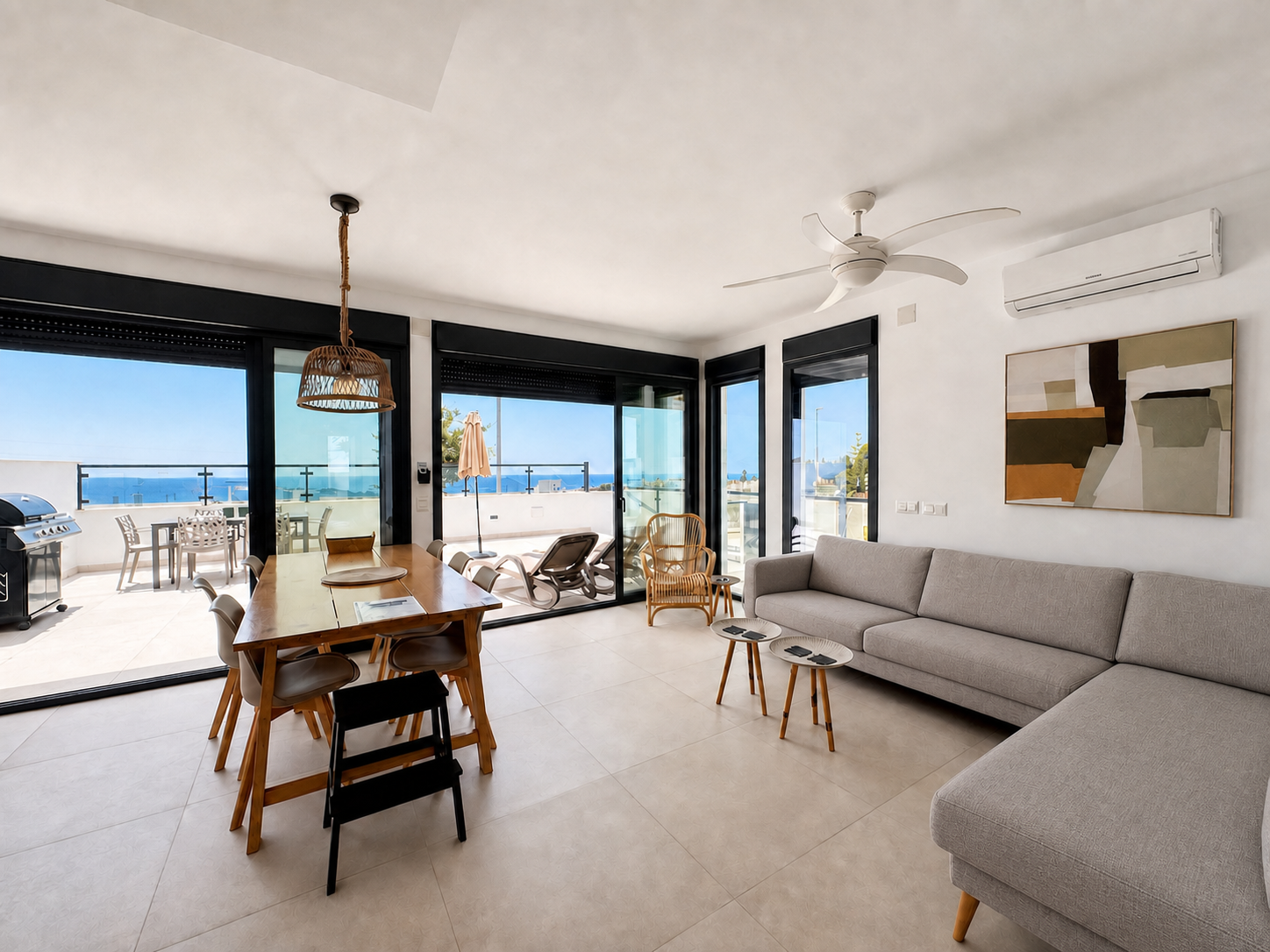 Living room with L-shaped sofa and terrace access