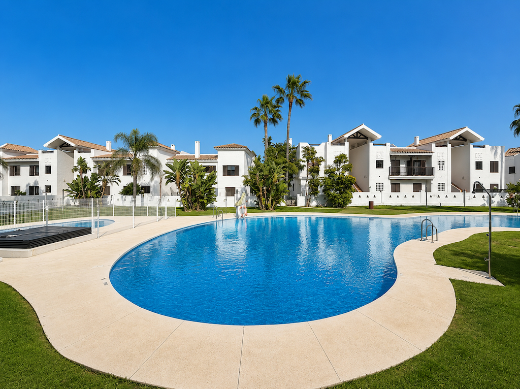 Outdoor communal pool with landscaped areas