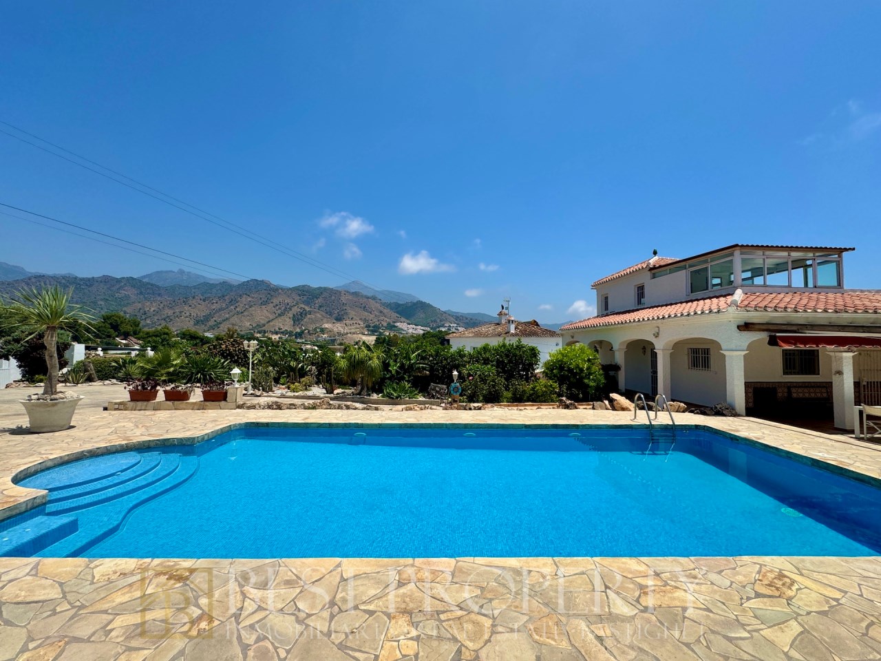 Pool with steps, garden and open valley views