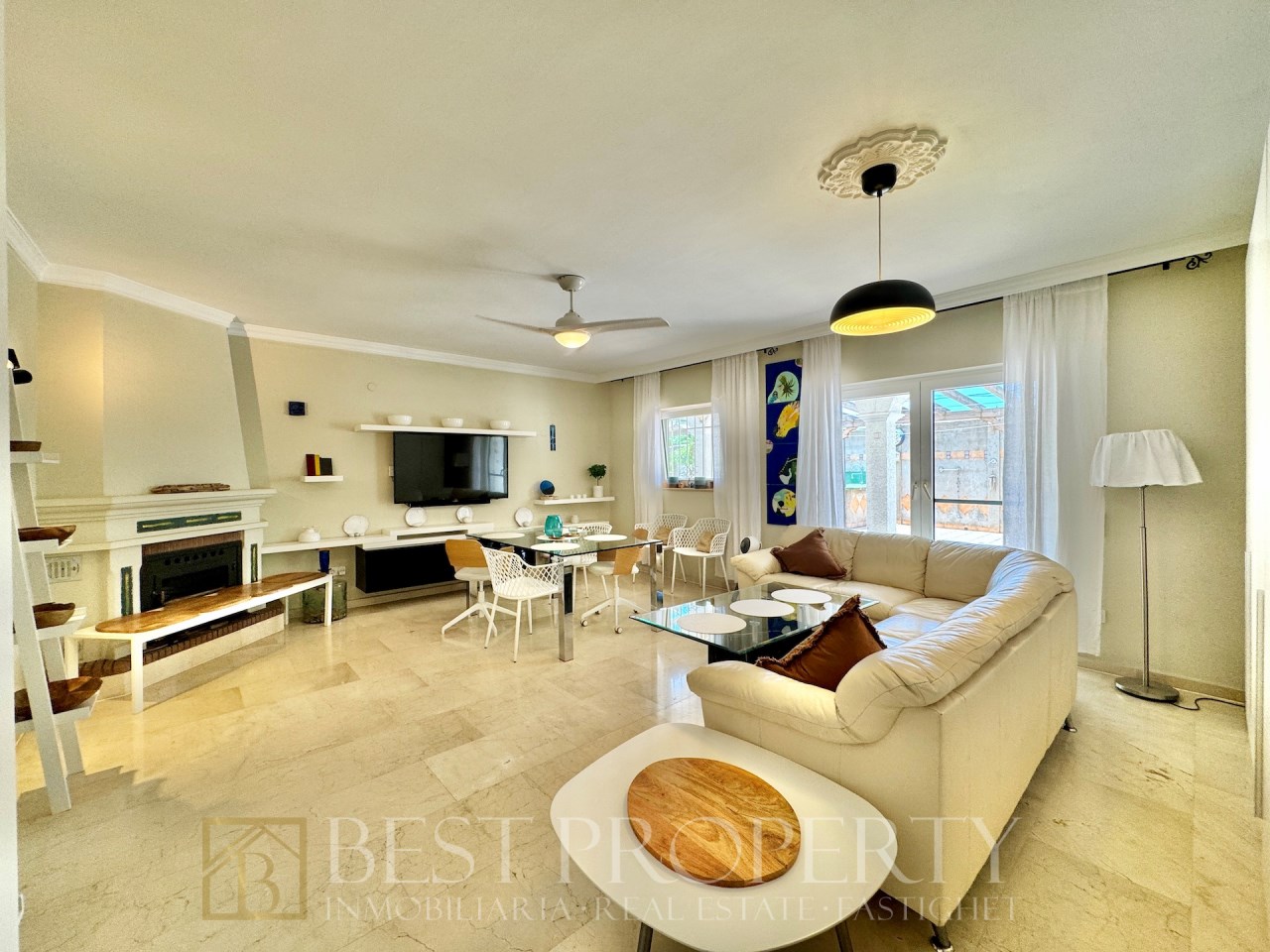Living room with sofa, TV and outdoor access
