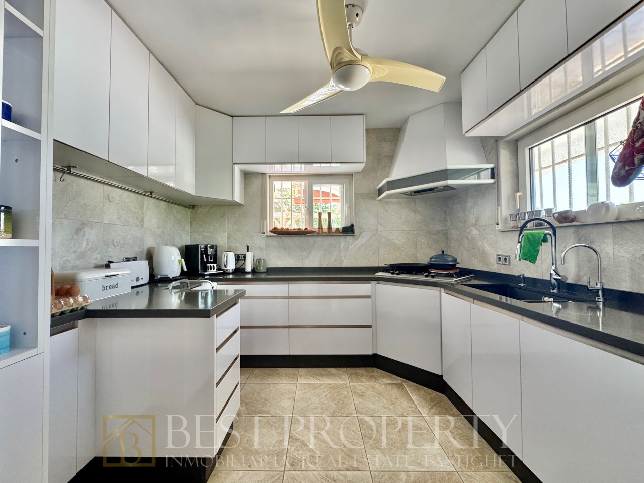 Modern U-shaped kitchen with dark countertop