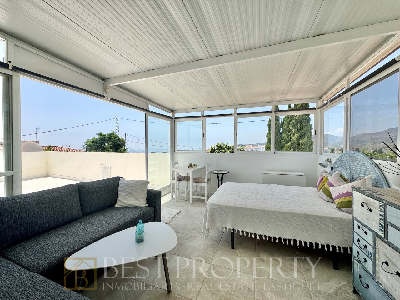Enclosed terrace with sofa and single bed
