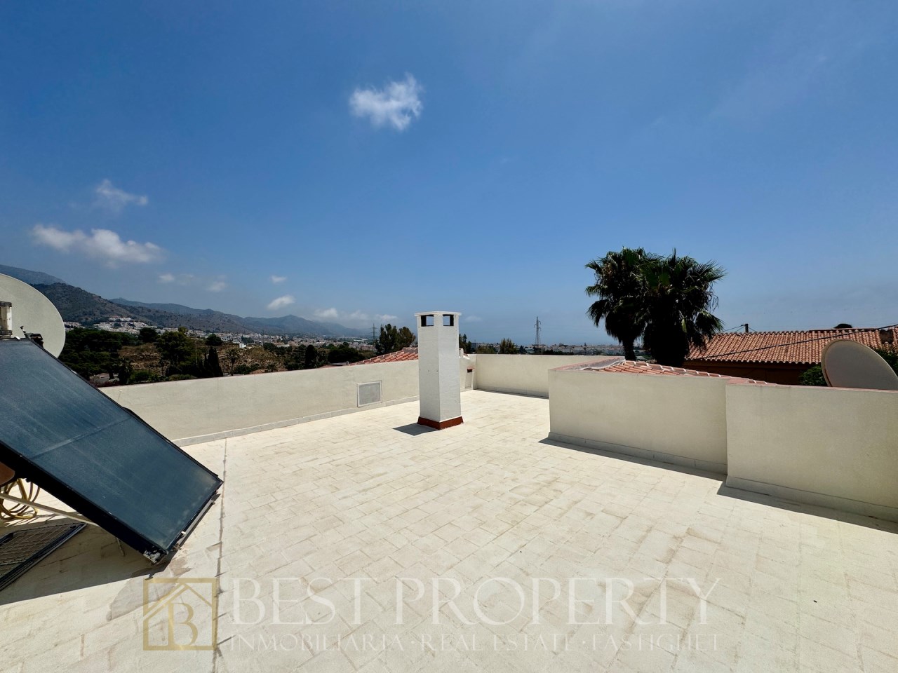 Large rooftop terrace with panoramic views and chimney