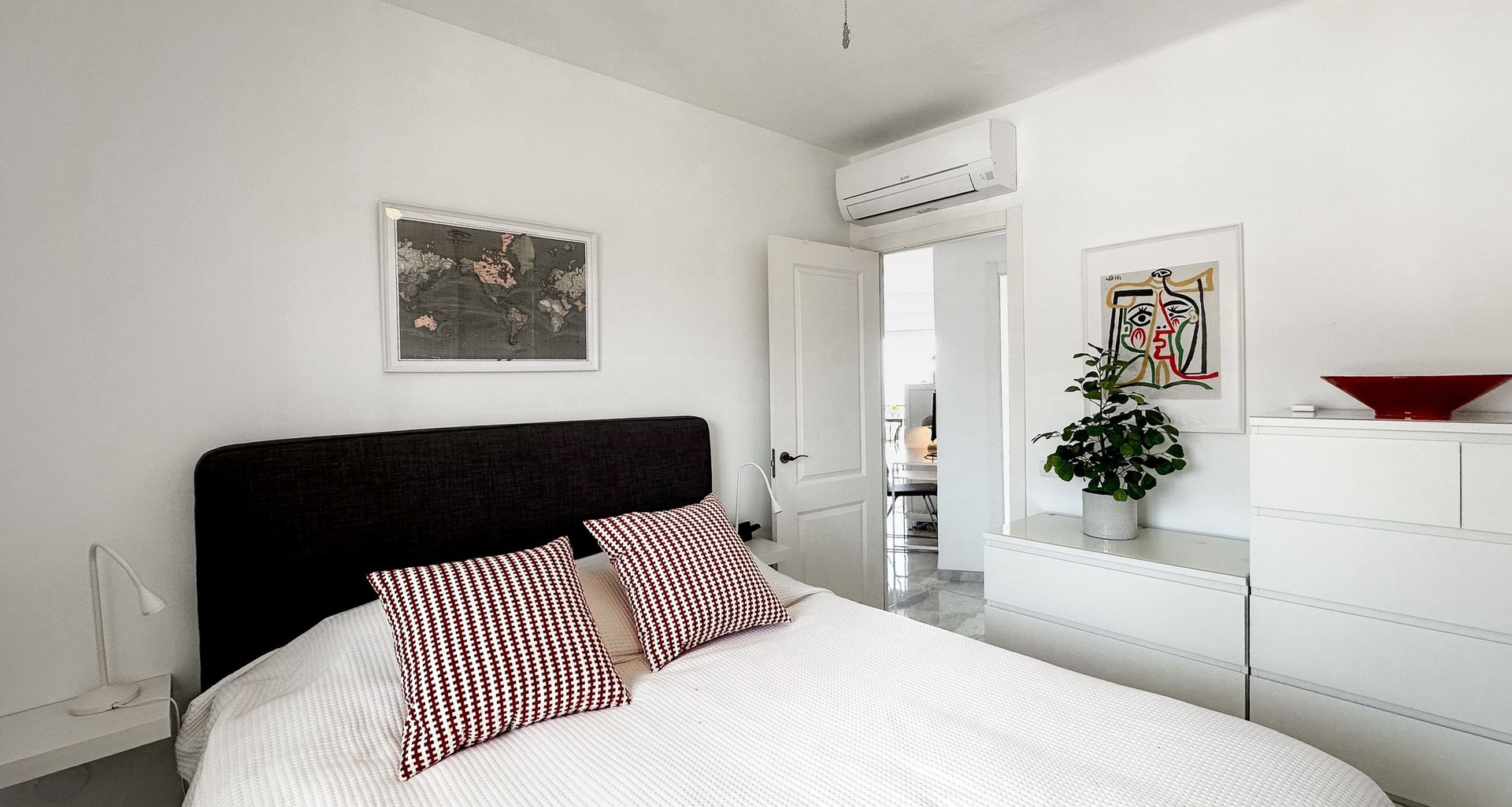 Bedroom with double bed and white wardrobes