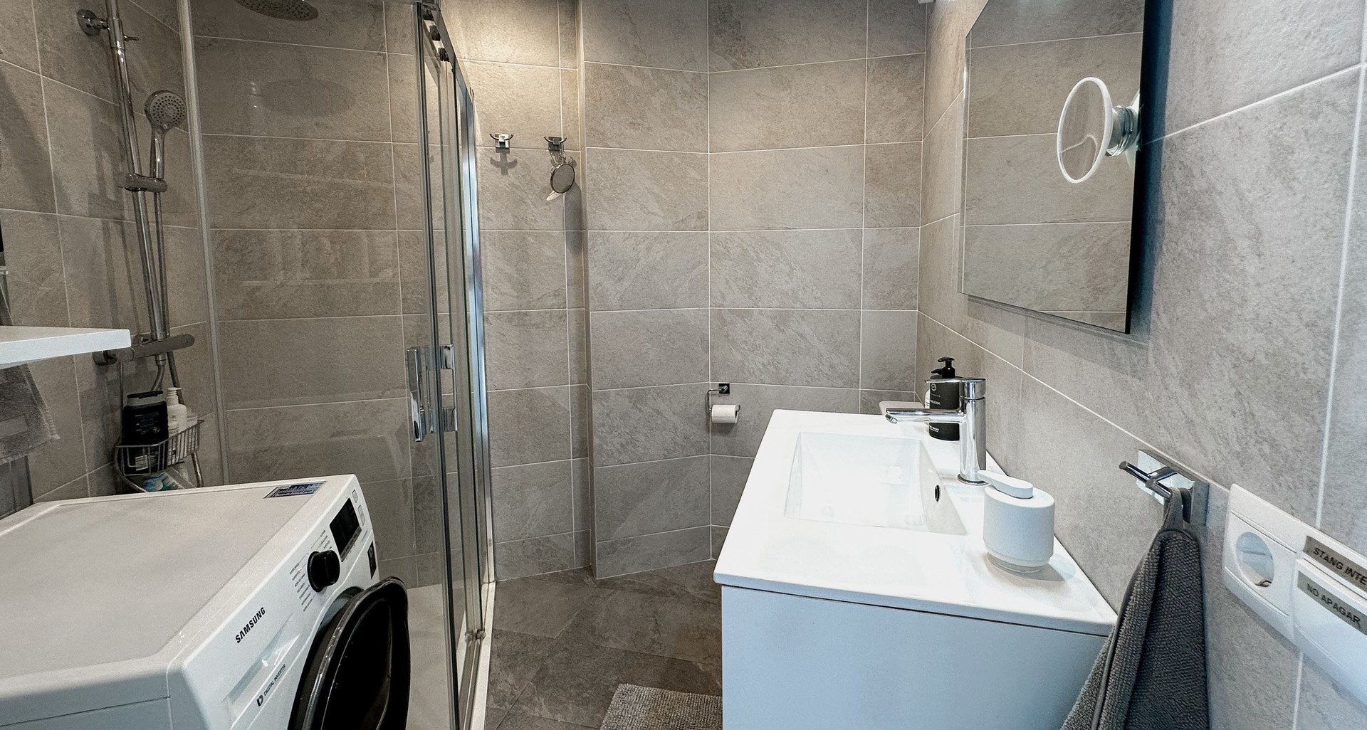 Utility room with washing machine and shower