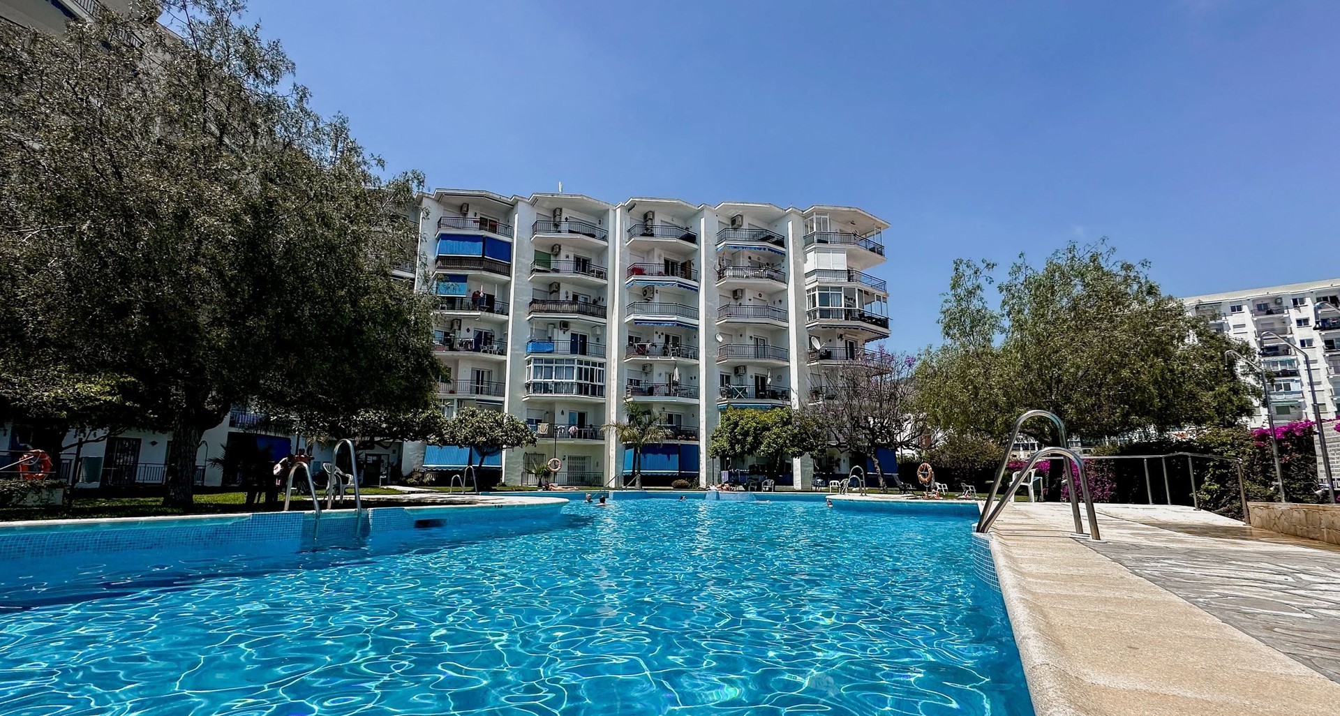 Large community pool with gardens