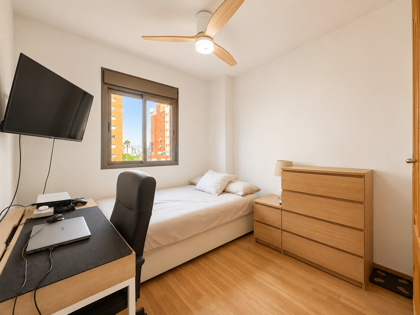 Single bedroom with desk, bed and TV