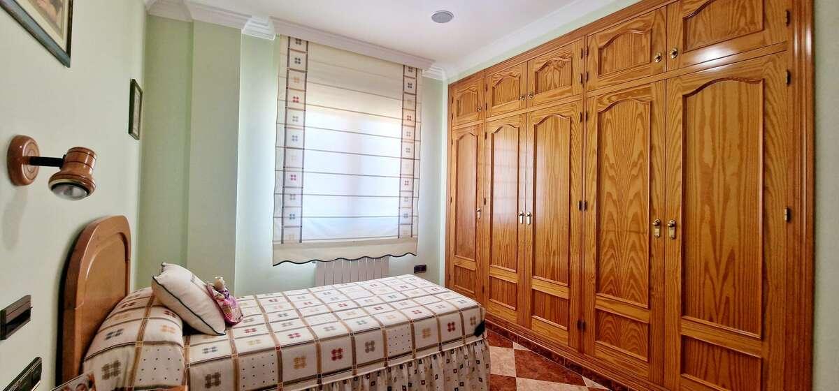 Bedroom with built-in wooden wardrobes