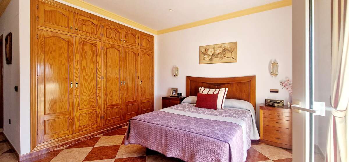 Double bedroom with built-in wardrobes and balcony