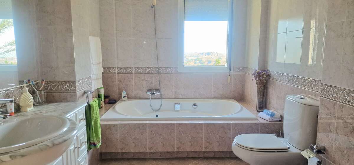 Full bathroom with bathtub and double sink