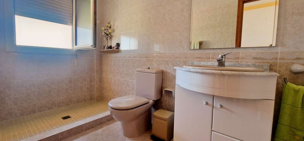 Bathroom with spacious shower and sink