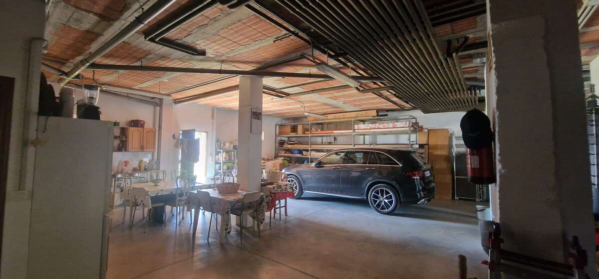 Large garage with car and storage area