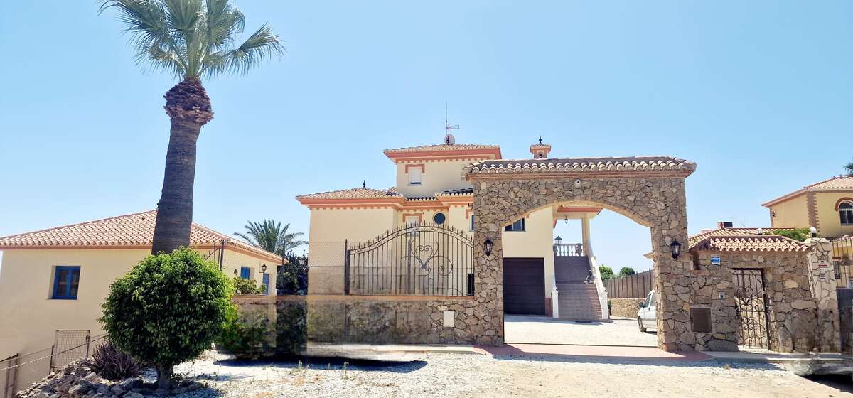 Exterior entrance of the villa with stone arch