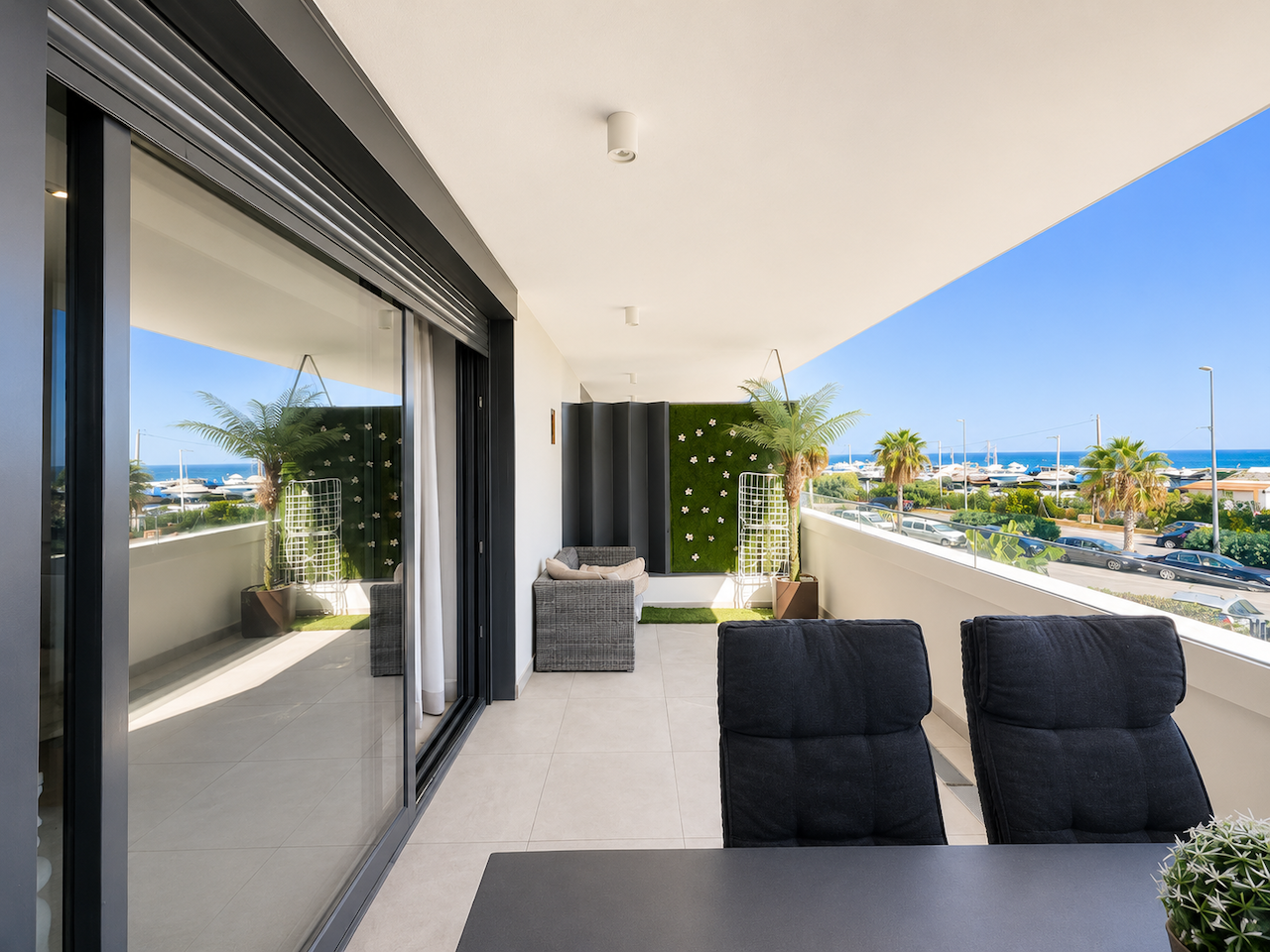 Covered terrace with outdoor seating and sea views