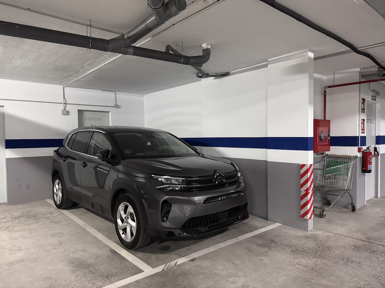 Underground garage parking space with car parked