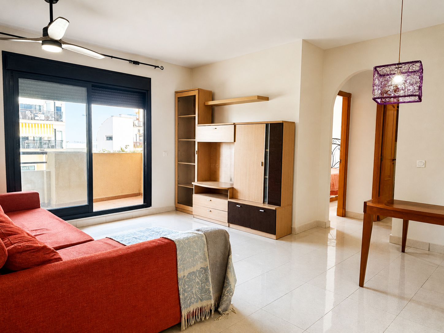 Living room with sofa and balcony access