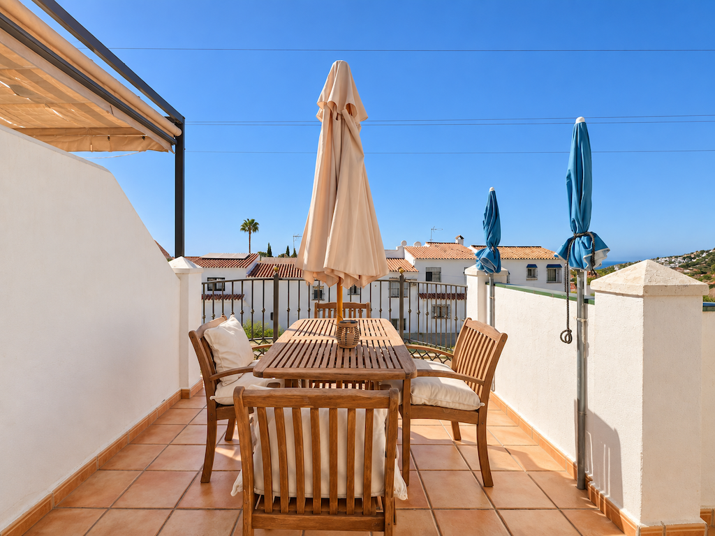 Terrace with outdoor table and neighborhood views