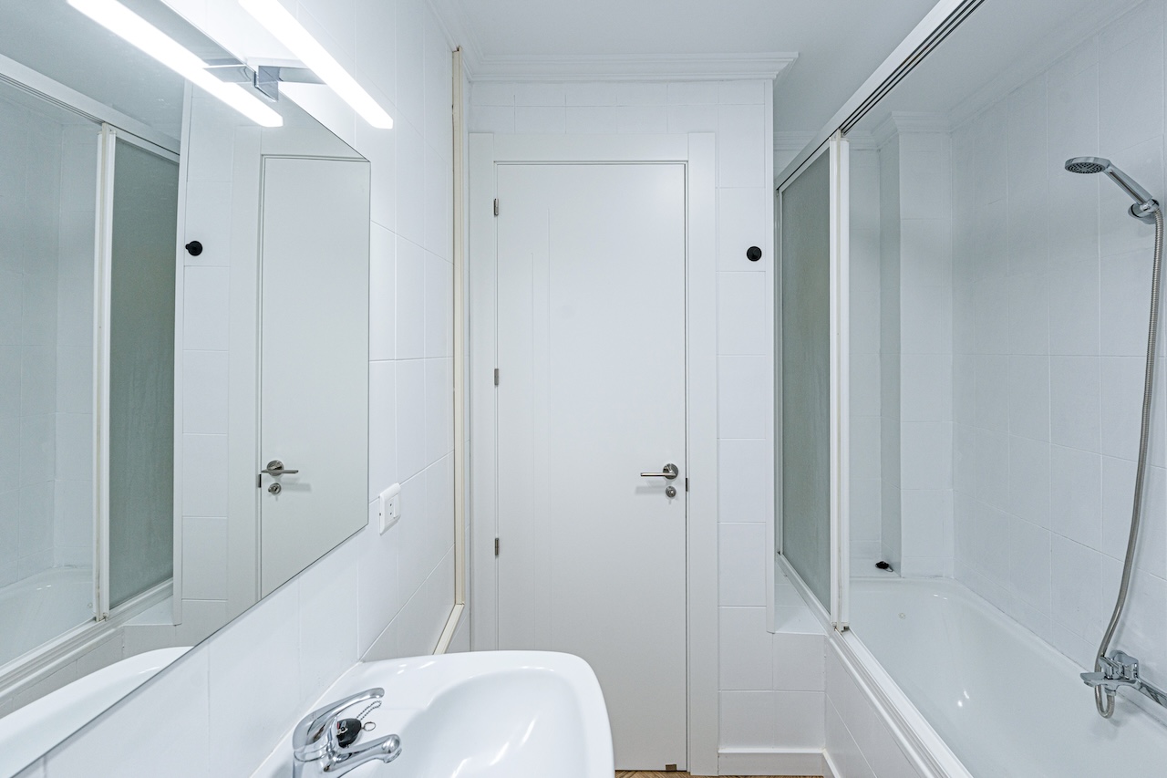 Bathroom with bathtub and shower, sink visible