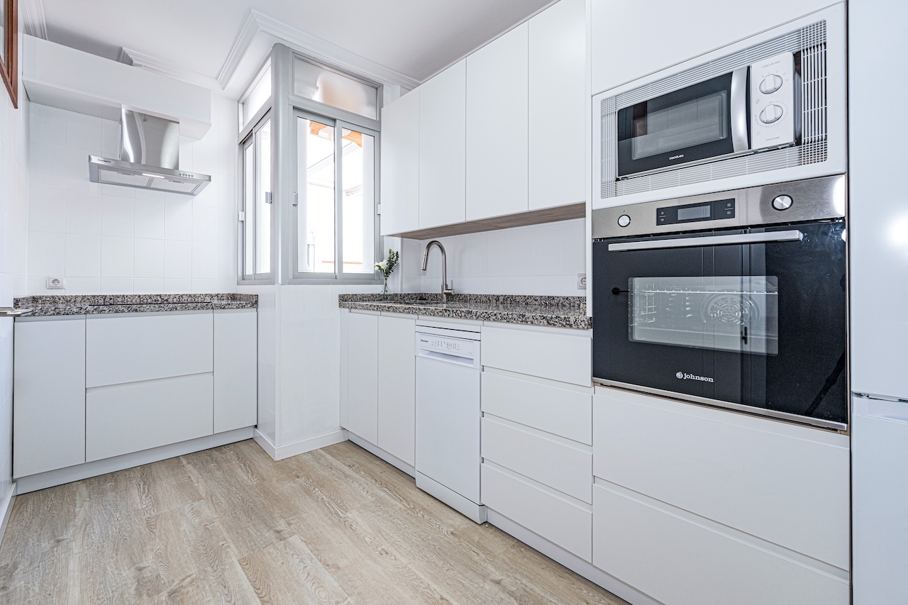 Modern white kitchen with integrated appliances