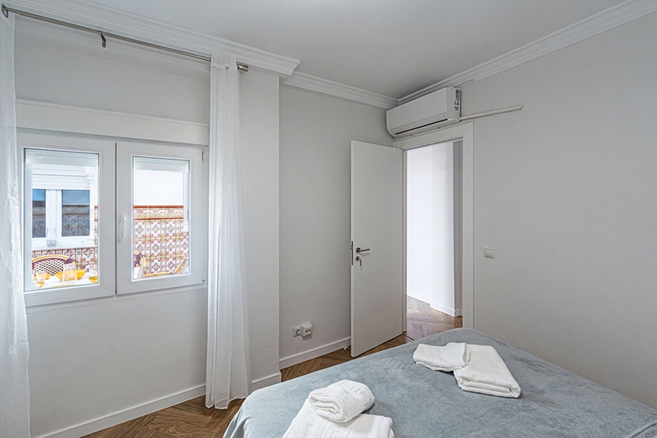 Bedroom with double bed and terrace views