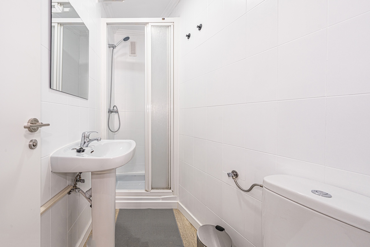 Small toilet with shower, sink and WC