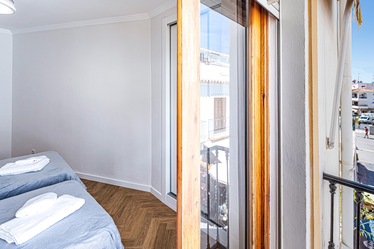 Double bedroom with balcony and street views