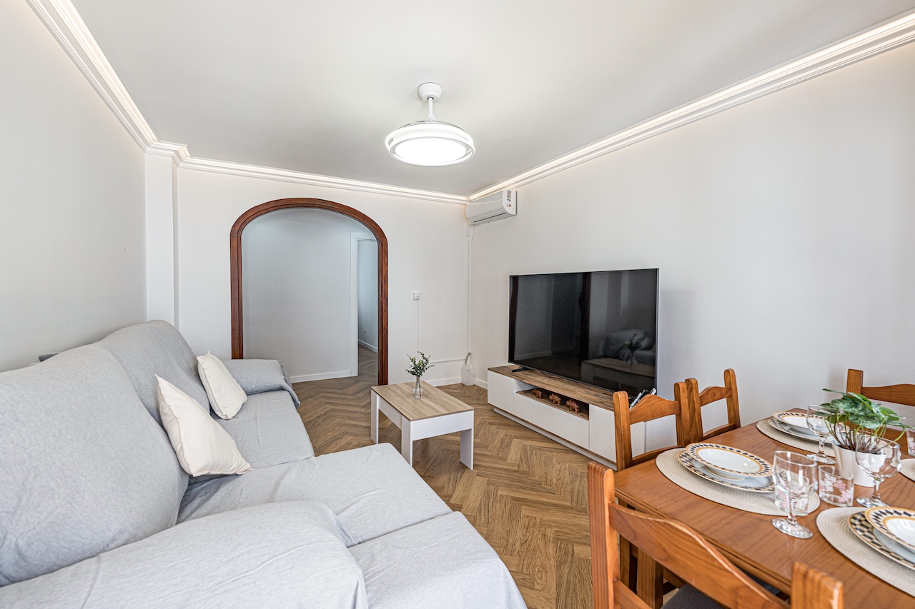 Living room with sofa, TV and dining table