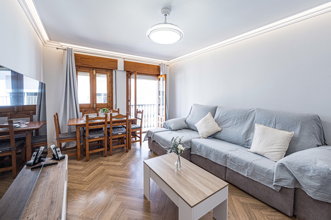 Spacious living room with corner sofa and dining area