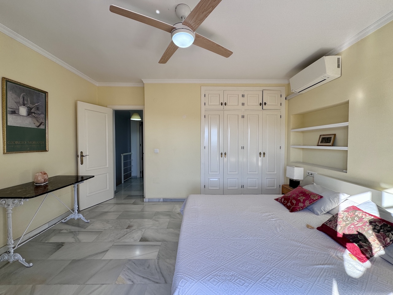 Bedroom with built-in wardrobe and hallway access